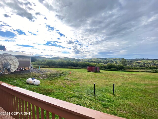 view of yard featuring a storage shed and a rural view