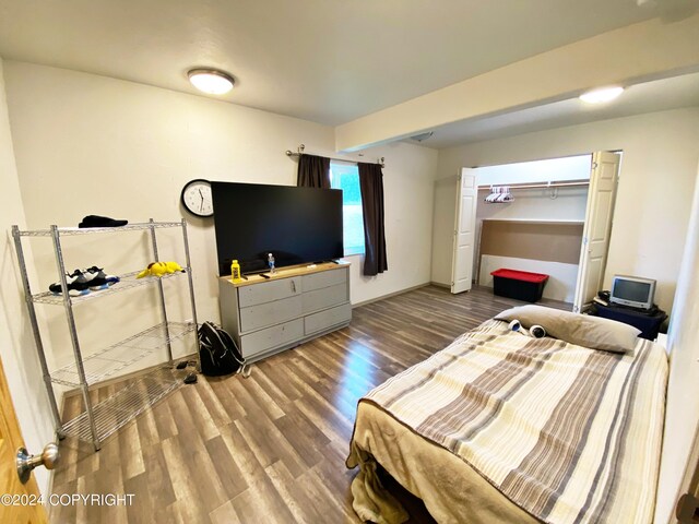 bedroom with hardwood / wood-style flooring and a closet