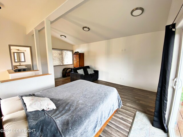 bedroom with lofted ceiling, hardwood / wood-style floors, and multiple windows