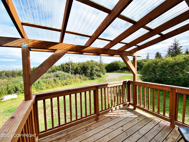 wooden terrace with a pergola and a yard