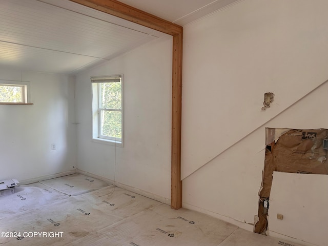 unfurnished room featuring lofted ceiling