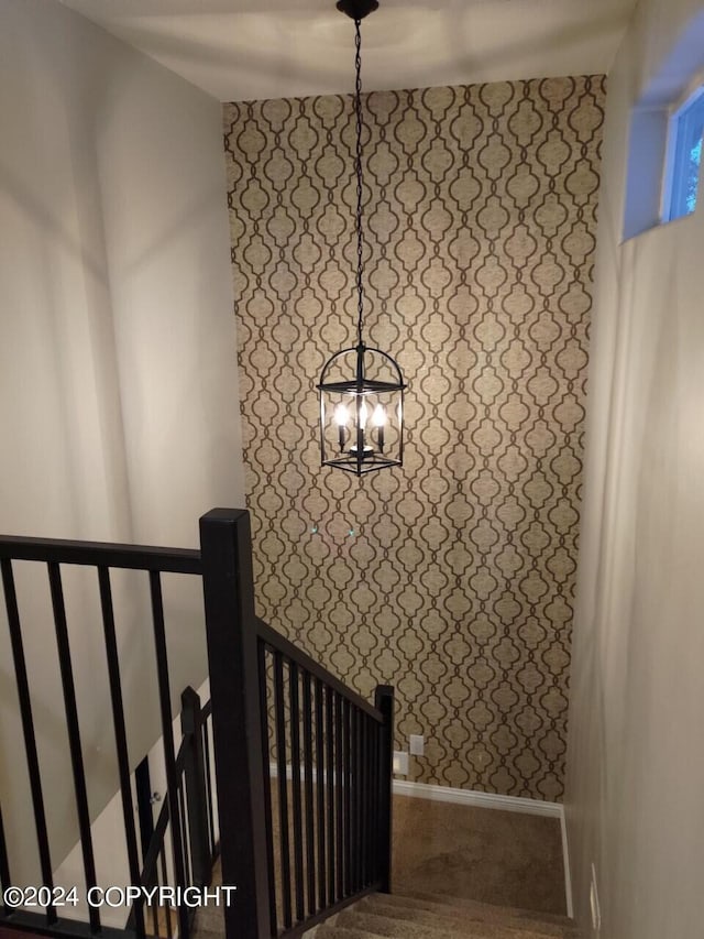 stairs with an inviting chandelier