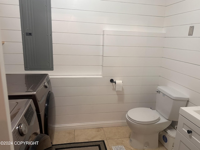 bathroom featuring electric panel, toilet, tile patterned floors, vanity, and separate washer and dryer