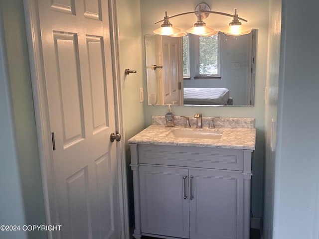 bathroom with ensuite bath and vanity