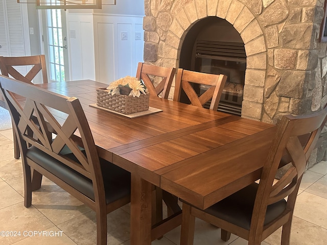 dining room featuring wainscoting and a decorative wall