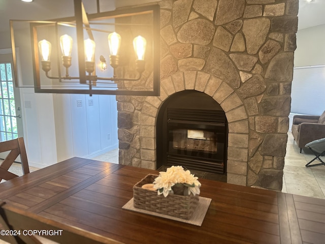 room details featuring a stone fireplace and wood finished floors