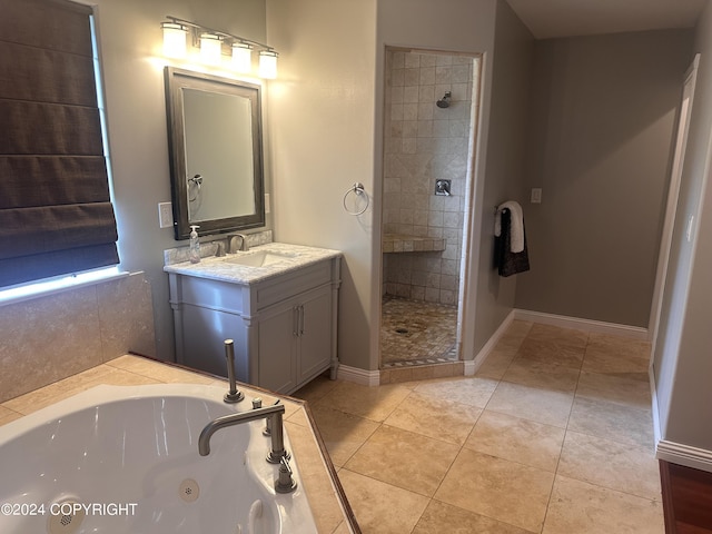 full bath with baseboards, tiled shower, a tub with jets, tile patterned floors, and vanity