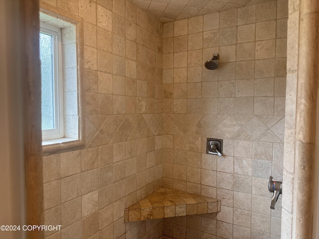 interior details with a tile shower