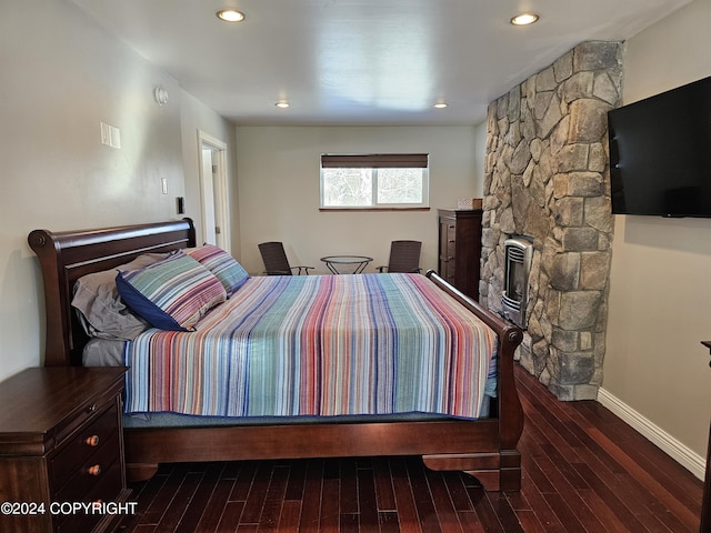 bedroom with a fireplace, baseboards, wood finished floors, and recessed lighting