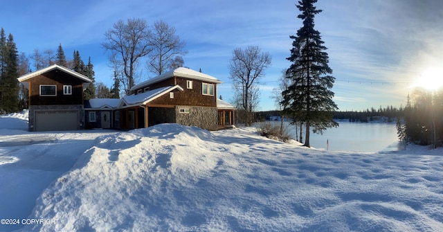 snowy yard with a garage