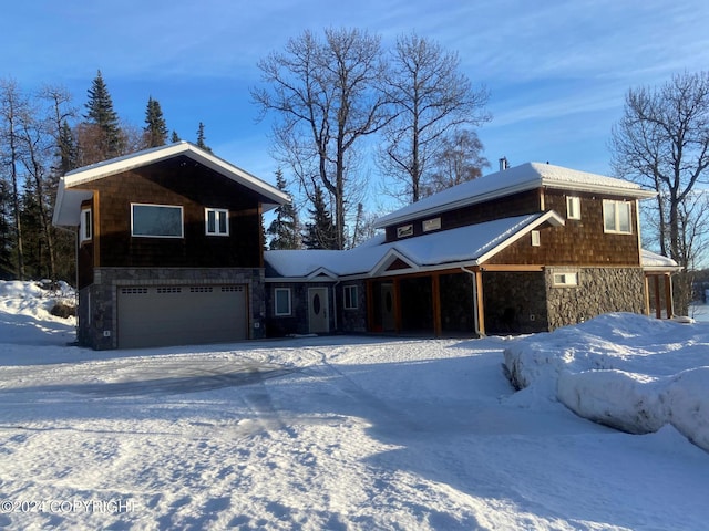 rustic home featuring a garage and stone siding