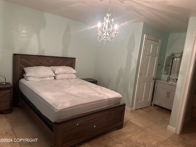 bedroom with light tile patterned floors, a chandelier, and baseboards