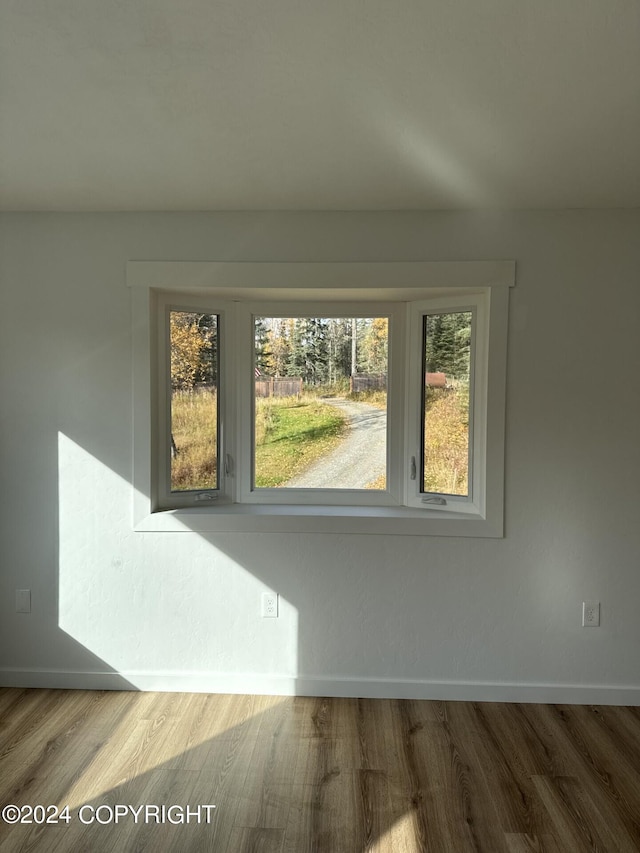 interior space featuring wood finished floors and baseboards