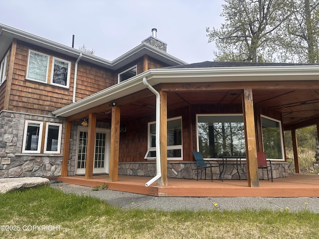 52305 Admiralty Dr, Nikiski/North Kenai, AK 99611 - rear view of house with stone siding and a chimney