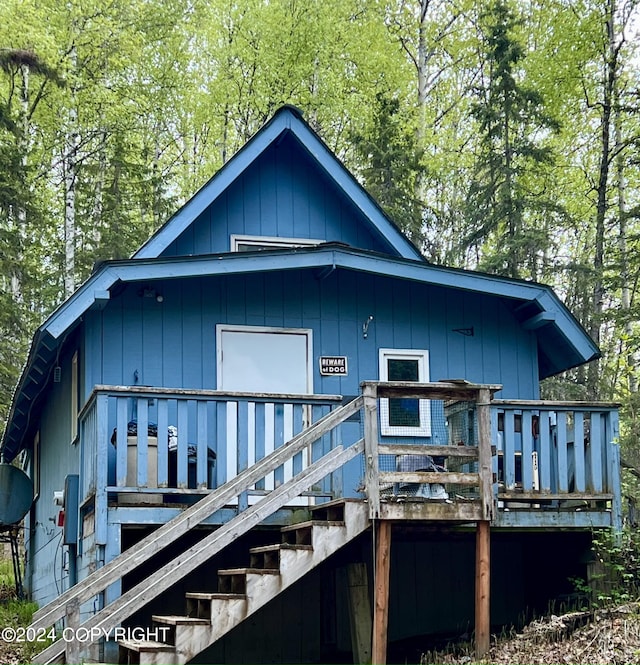 back of house featuring a wooden deck