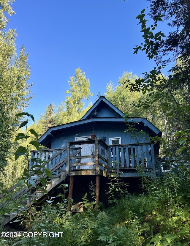 rear view of house with a wooden deck