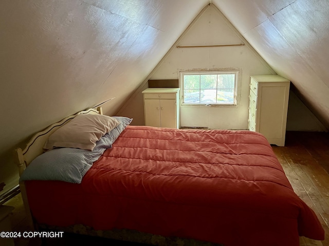 bedroom featuring vaulted ceiling and hardwood / wood-style floors