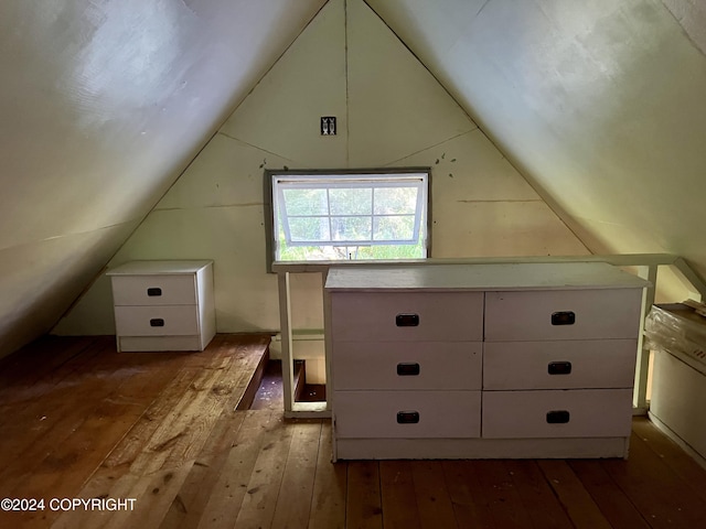 bonus room with lofted ceiling and hardwood / wood-style flooring