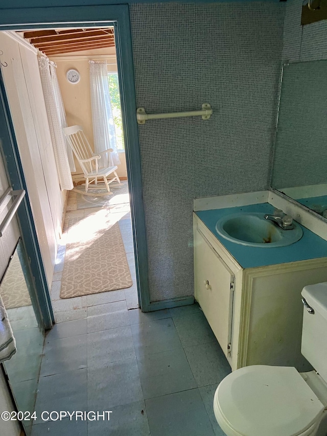 bathroom with tile patterned flooring, vanity, and toilet