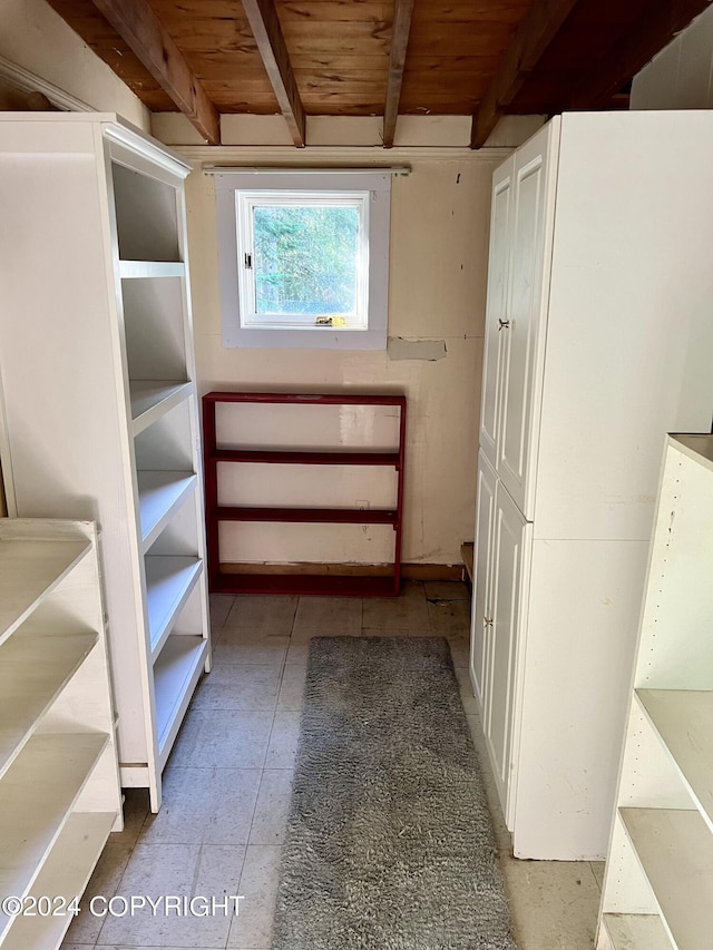 spacious closet featuring beam ceiling