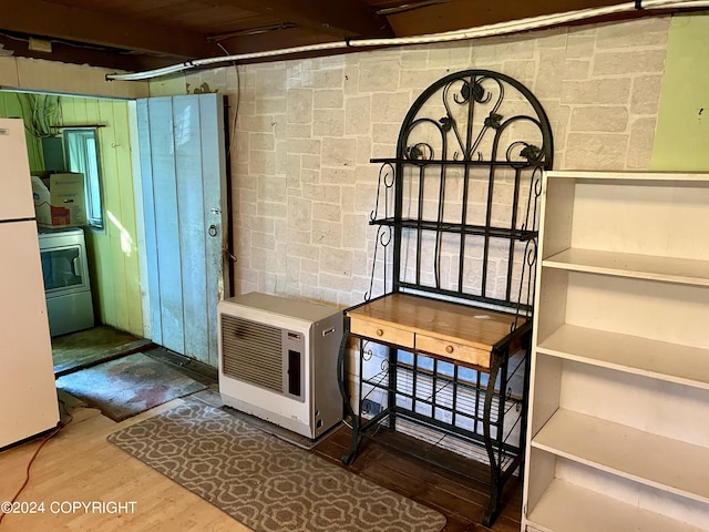 interior space featuring washer / clothes dryer, hardwood / wood-style flooring, and heating unit