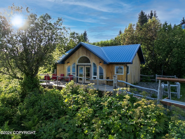 rear view of property featuring a wooden deck