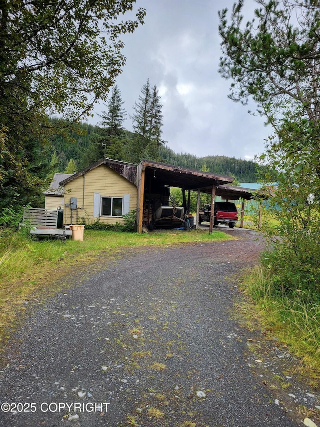 exterior space featuring a water view and a carport