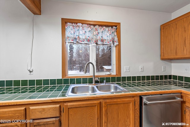 kitchen featuring dishwasher, tile counters, and sink