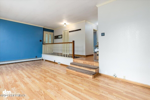 empty room with light hardwood / wood-style flooring, baseboard heating, and ornamental molding