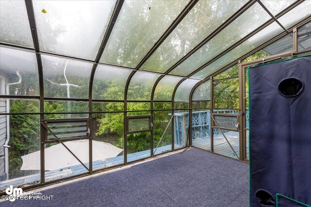 unfurnished sunroom with vaulted ceiling