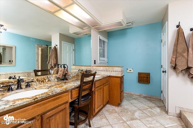 bathroom with tile patterned floors and vanity