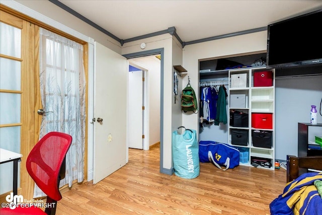 recreation room with hardwood / wood-style flooring and crown molding