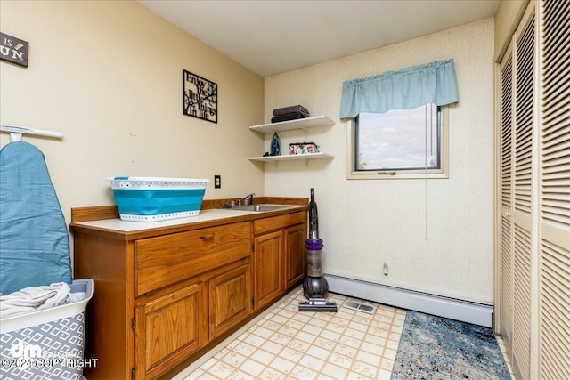 interior space with baseboard heating and sink