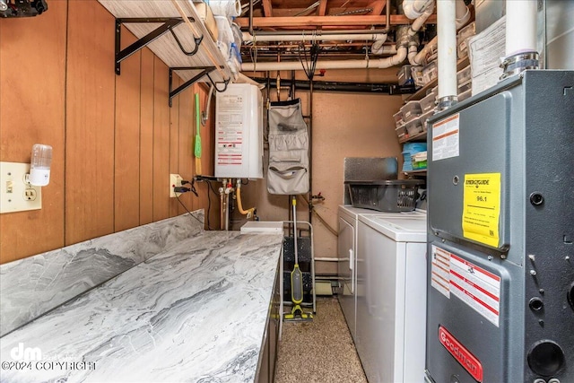 utility room featuring water heater and washing machine and dryer