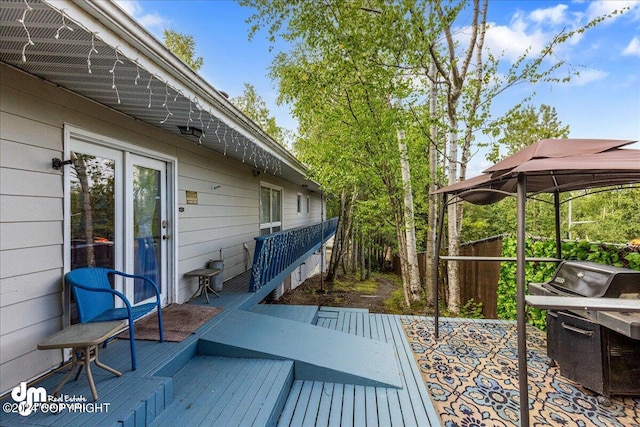 wooden deck with a grill and a gazebo