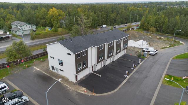 birds eye view of property with a forest view