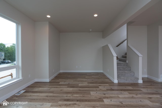 interior space with recessed lighting, visible vents, wood finished floors, and stairs