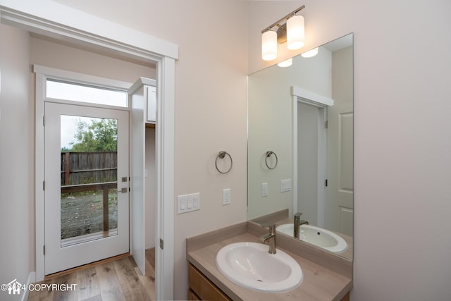 bathroom with vanity and wood finished floors