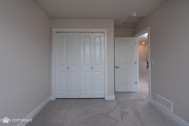 unfurnished bedroom featuring a closet, visible vents, baseboards, and carpet