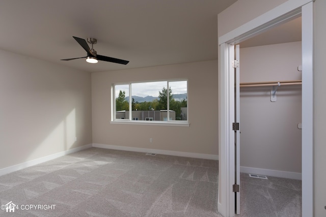 unfurnished bedroom with visible vents, a ceiling fan, a closet, carpet floors, and baseboards