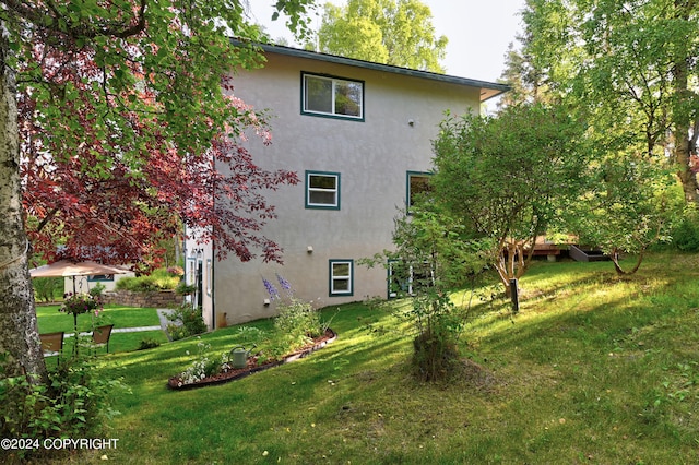 view of side of home featuring a yard