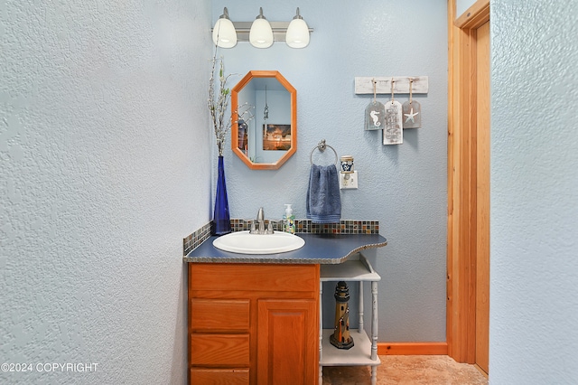 bathroom featuring tile patterned flooring and vanity