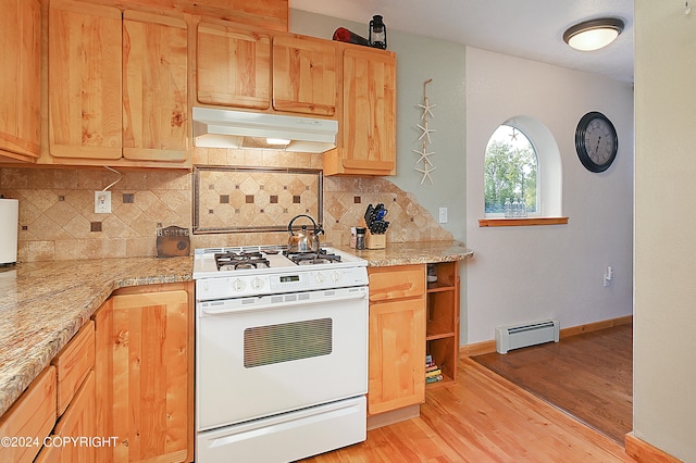 kitchen featuring light stone countertops, light wood-type flooring, tasteful backsplash, baseboard heating, and white range with gas cooktop