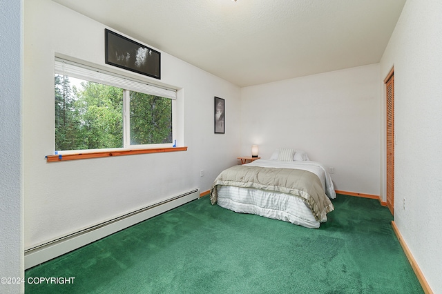 carpeted bedroom featuring a closet and a baseboard heating unit