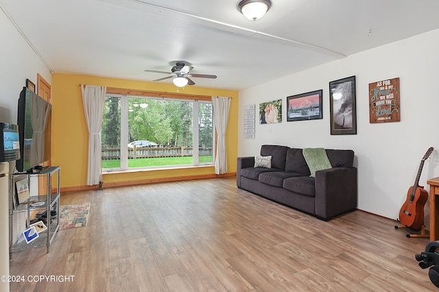 living room featuring ceiling fan and light hardwood / wood-style floors