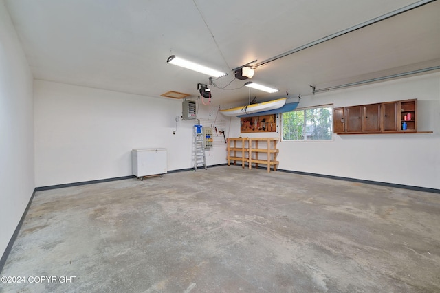 garage with a workshop area and a garage door opener