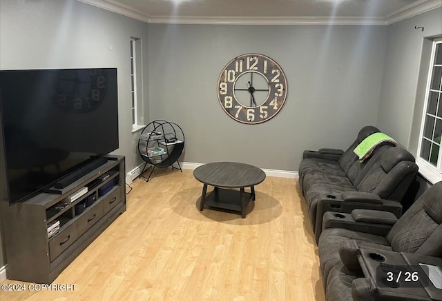 living room featuring crown molding and light hardwood / wood-style floors