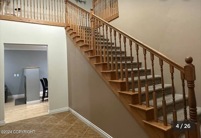 stairway with tile patterned floors