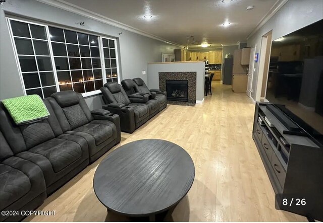 living room featuring light wood-type flooring and ornamental molding