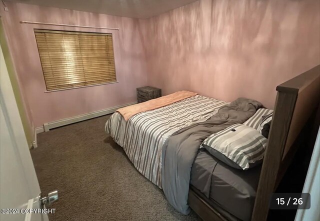 bedroom featuring baseboard heating and dark colored carpet